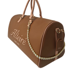 Brown duffle bag sideview with accessory